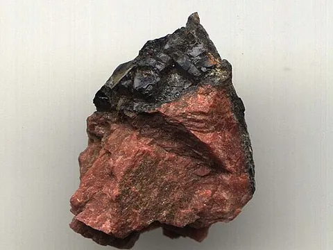 gadolinite: a dark, vitreous mineral that is a complex mixture of silicates of cerium, lanthanum, neodymium,...