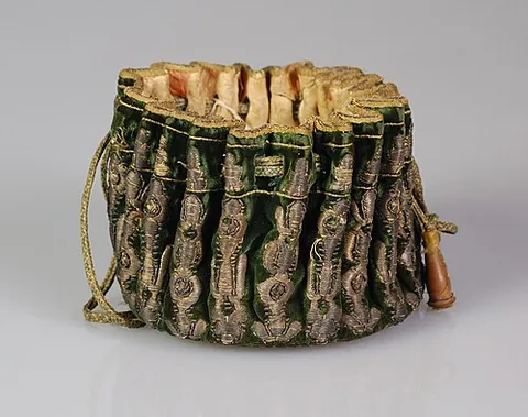 gaming purse: a small drawstring bag with a flat, circular base and pleated sides, used by gamblers for coins or...