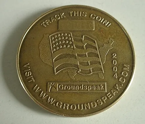 geocoin: a coin minted for use as a prize in geocaching, sometimes trackable on the Internet by its serial...