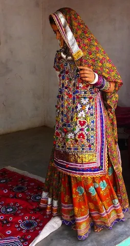 ghagra: a long ornamented skirt or petticoat, tightened with a drawstring and often hung with bells, worn...