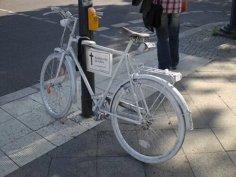 ghost bike: a bicycle painted white and set up as a roadside memorial to indicate where a cyclist was killed by...