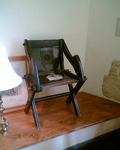 glastonbury chair: a kind of wooden chair, usually of oak, with crossing legs and sloped back