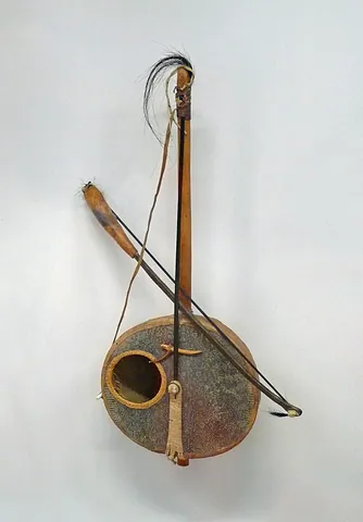 goje: a fiddle-like stringed instrument with one or two strings, and a resonator made from a gourd or...