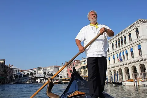 gondolier: a boatperson who propels a gondola, especially in Venice