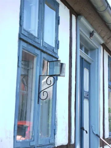 gossip mirror: a mirror or pair of mirrors mounted outside a window, allowing the viewer to see along a street...