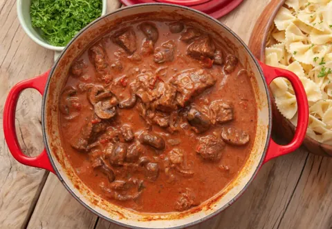 goulash: a stew of beef or veal and vegetables, flavoured with paprika