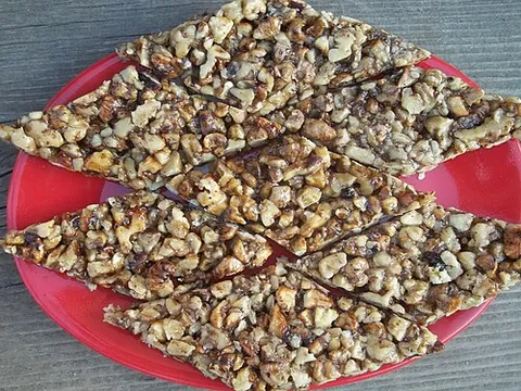 gozinaki: a traditional Georgian confection made of nuts sliced into small pieces, usually walnuts, fried in...
