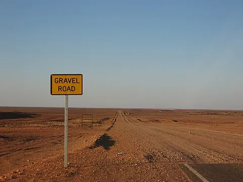 gravel road: a road with a gravel surface, instead of asphalt, bitumen or concrete