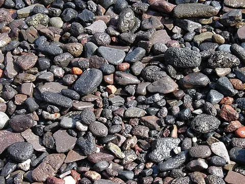gravelly: full of, covered with, or similar to gravel or pebbles