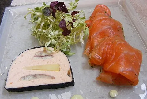 gravlax: salmon dry-cured in salt, seasoned with dill and sugar, and served usually thinly sliced as an...