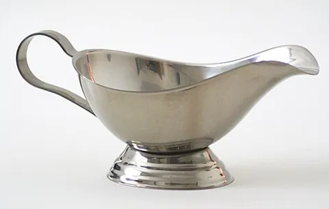 gravy boat: a dish with a handle and spout, used to serve gravy or other sauces