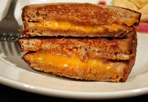 grilled cheese: a cheese sandwich typically toasted or fried in butter