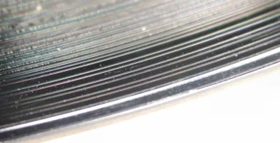 groove: a long, narrow channel or depression; e.g., such a slot cut into a hard material to provide a...