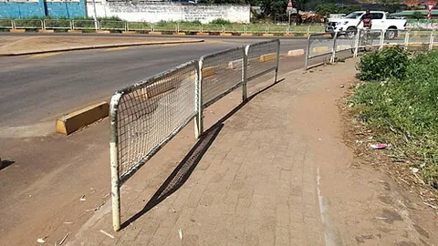 guardrail: a rail set alongside a dangerous place as a barrier, to improve safety