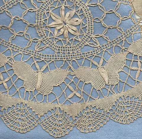 guipure: a kind of bobbin lace that connects the motifs with bars or plaits rather than net or mesh