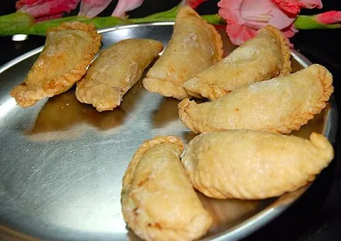 gujiya: a sweet dumpling of Indian origin, made with suji or maida flour and stuffed with khoa