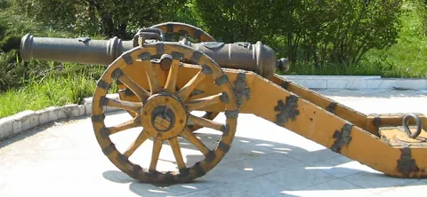 gun carriage: a metal or wooden frame on which a piece of ordnance is mounted for firing or transportation