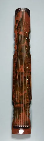 guqin: a plucked zither-like stringed instrument (chordophone), traditionally featuring seven unfretted...