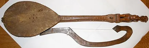 gusle: a single-stringed lute-like musical instrument with a bowl-shaped body, held vertically in the lap...