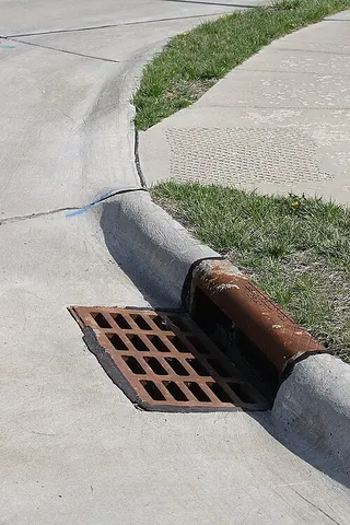 gutter: a prepared channel in a surface, especially at the side of a road adjacent to a curb, intended for...