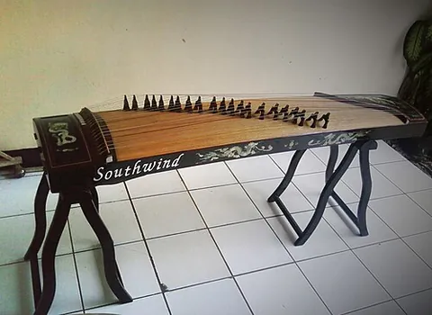 guzheng: a zither-like stringed instrument with at least eighteen strings and moveable bridges, played with...