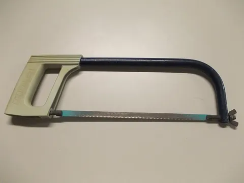 hacksaw: a saw, with a blade that is put under tension, for cutting metal