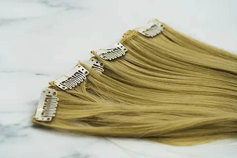 hair extension: a length of hair which is attached to one's normal hair to make it longer