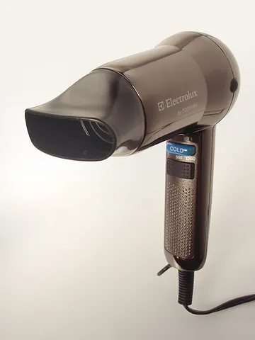 hairdryer: a small electrical appliance for drying hair, by generating a stream of hot air