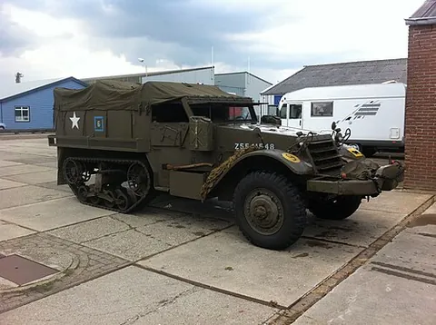 half-track: a vehicle combining both wheels and treads (caterpillar tracks)