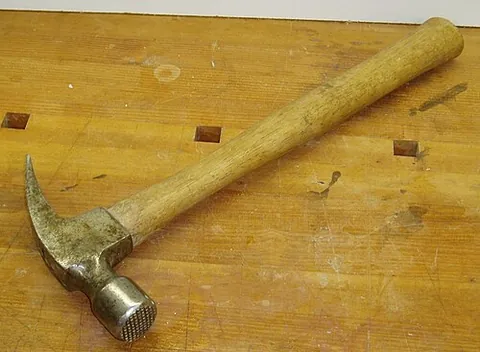 hammer: a tool with a heavy head and a handle used for pounding