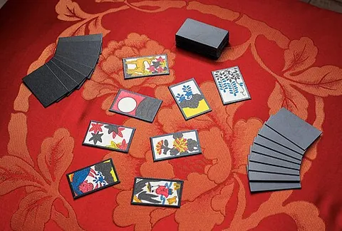 hanafuda: small, rigid Japanese playing cards with colorful drawings of flowers and animals, a single deck...