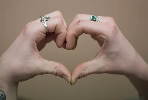 hand heart: a gesture in which a person forms a heart shape using their fingers