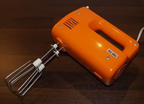 hand mixer: a hand-held mixer typically used as kitchen implement