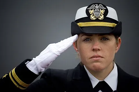 hand salute: a gesture of respect to someone or something by raising the right hand to the side of one's head