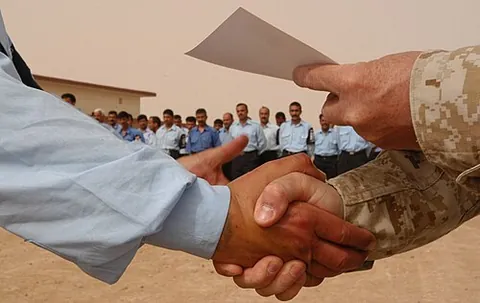 handshake: the grasping of hands by two people when greeting, leave-taking, or making an agreement