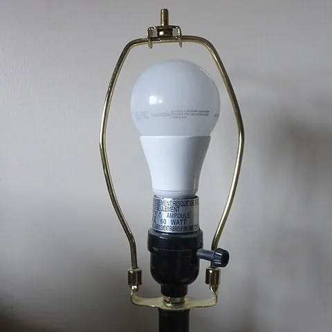harp holder: a wire framework that surrounds a lightbulb which fits into a socket at its base and which is...