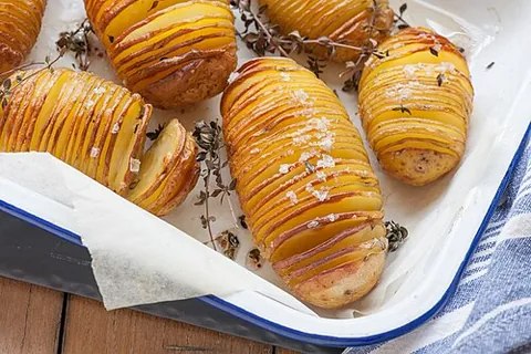 hasselback potatoes: a dish of potatoes sliced very thin, but with the bottoms left intact, and then baked and...