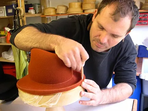 hatmaker: someone who makes hats