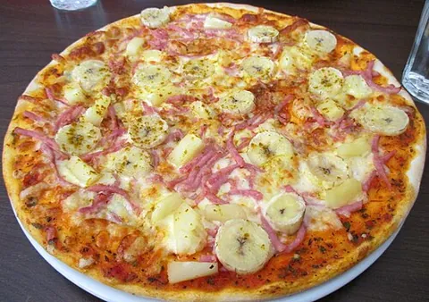 hawaiian pizza: a pizza topped with tomato sauce, cheese, pineapple, and back bacon or ham