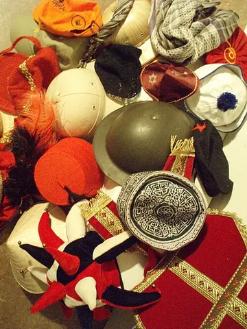 headgear: anything worn on the head, such as a hat, hood, helmet, etc