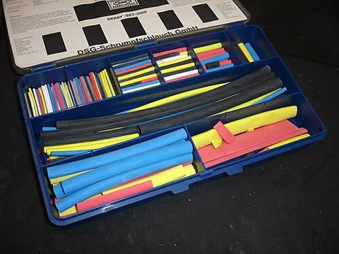 heat shrink: a plastic tube that shrinks when heated, used as a mantle for wiring. The heating is typically with...