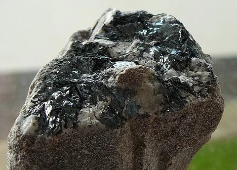 hematite: an iron ore, mainly peroxide of iron, Fe₂O₃: iron(III) oxide