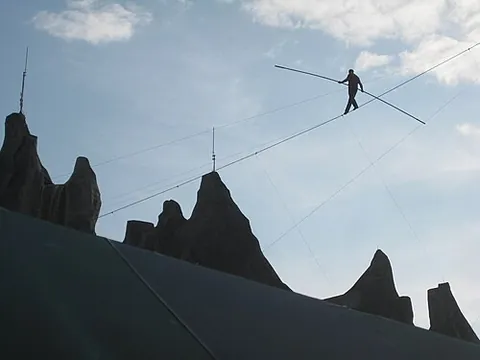 highwire walker: an acrobat who performs tightrope walking on a wire which is at an especially high elevation above...