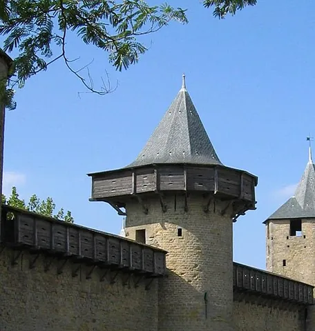 hoarding: a roofed wooden shield placed over the battlements of a castle and projecting from them