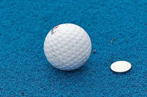 hockey ball: a small hard ball used in the sport of hockey (field hockey)