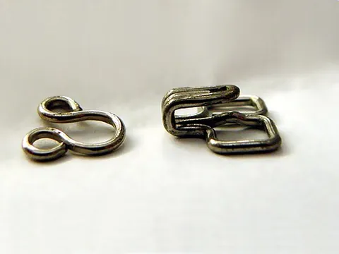 hook and eye: a matched hook and an eye (loop into which the hook can fit), used for fastening