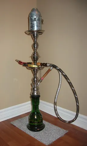 hookah: a pipe with a long flexible tube that draws the smoke through water, traditionally used for smoking...