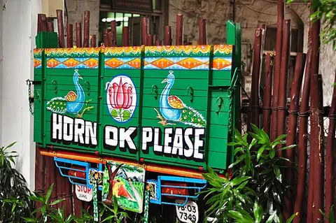 horn ok please: a request to honk before overtaking a commercial vehicle that is written on the rear end