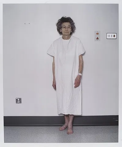 hospital gown: a gown worn by patients, typically being knee-length, having short sleeves, and being secured on...
