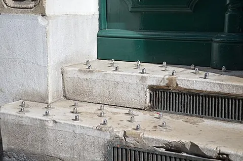 hostile architecture: a type of architecture and design strategy for buildings, roads, park benches, etc, which aims to...